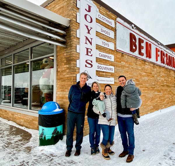 Former Joynes Department Store and Ben Franklin owners Jim and Shanie Joynes stood with new owners Jessica Dean, holding son Asher, and Tyler Dean, ho
