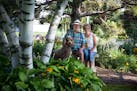 Beautiful Garden winners Duane Miller and Mary Ann O'Brien, with their dog Cooper, design, plant and tend their 1-acre lot in Stillwater.