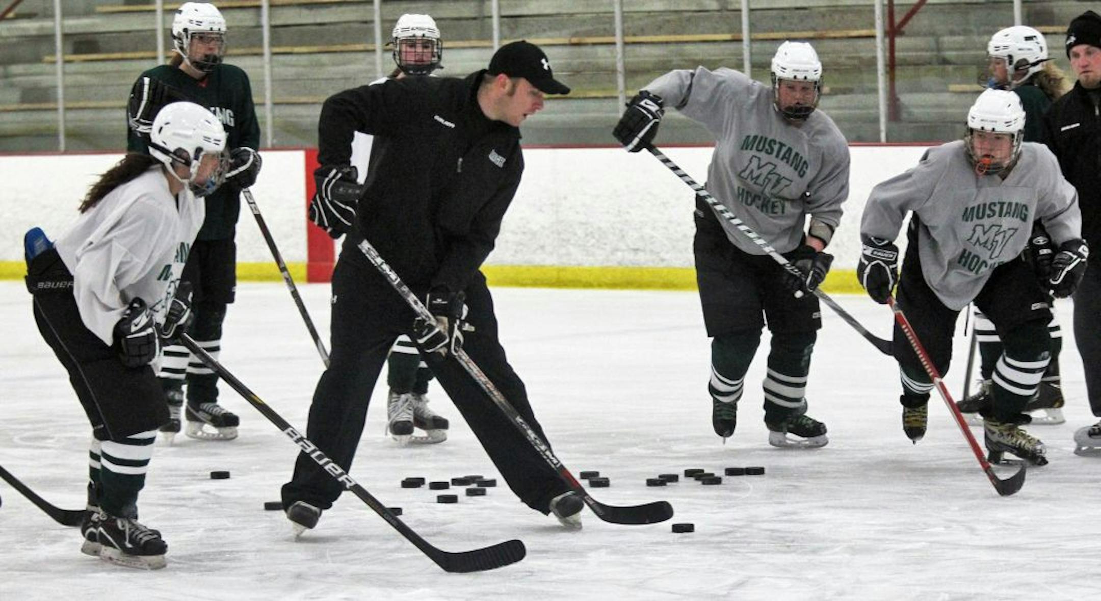 Mounds View girls' hockey coach Aaron Moberg worked on fundamentals with his squad during a recent practice. Photo by Marlin Levison • mlevison@startribune.com