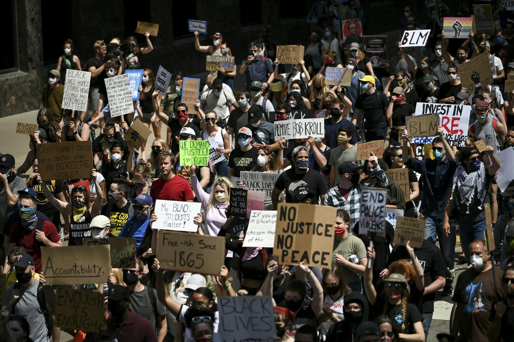 Hundreds of protesters marched through downtown Minneapolis Saturday while taking part in the "International Solidarity Day of Protest Against Police Terror."