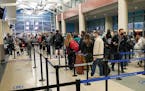 Holiday travelers waited in line to get through TSA security at Terminal 2 of the Minneapolis-St. Paul International Airport on Nov. 22, 2021.