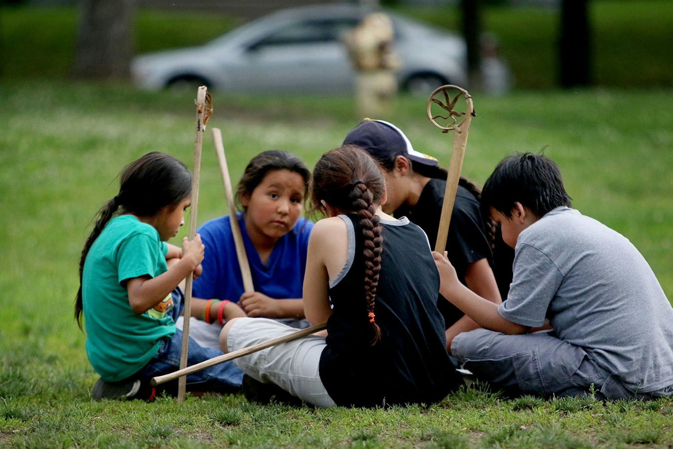 Youth boys team members of Twin Cities Native Lacrosse break from practice to discuss strategy before resuming scrimmage with teammates at Corcoran Park Wednesday, June 17, 2015, in Minneapolis, MN. The traditional Lacrosse players, who play with hand carved ash sticks, were preparing for the upcoming Twin Cities Native Lacrosse Tournament at the Osseo High School Saturday.
