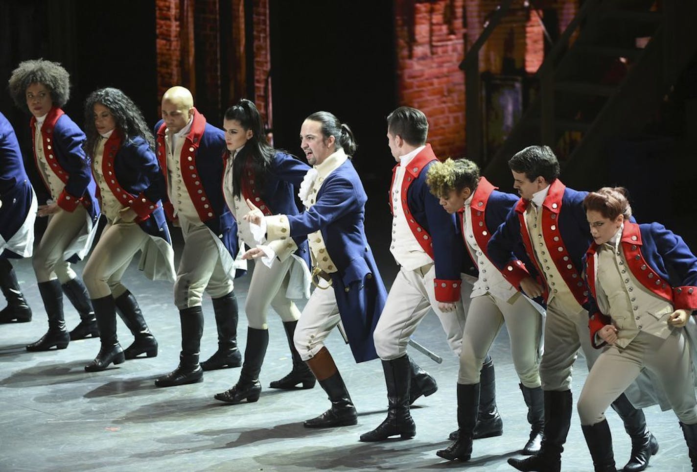 FILE - In this June 12, 2016 file photo, Lin-Manuel Miranda, center, and the cast of "Hamilton" perform at the Tony Awards in New York. Ever since the historical musical began its march to near-universal infatuation, one group has noticeably withheld its applause, historians. Many academics argue the onstage portrait of Alexander Hamilton is a counterfeit. Now they're escalating their fight.