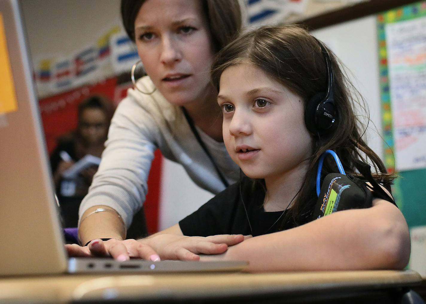 Emerson Spanish Immersion after school Focus for Success student Rosie Russell uses neurofeedback: NASA-inspired computer games by Play Attention that are powered by sensors reading one's brain waves during the after school program Thursday, Jan. 17, 2019, in Minneapolis, MN. Looking on is second grade teacher Brianna Jensen, the program's creator.] DAVID JOLES &#x2022; david.joles@startribune.com Emerson Spanish Immersion second grade teacher Brianna Jensen has launched a new afterschool progra