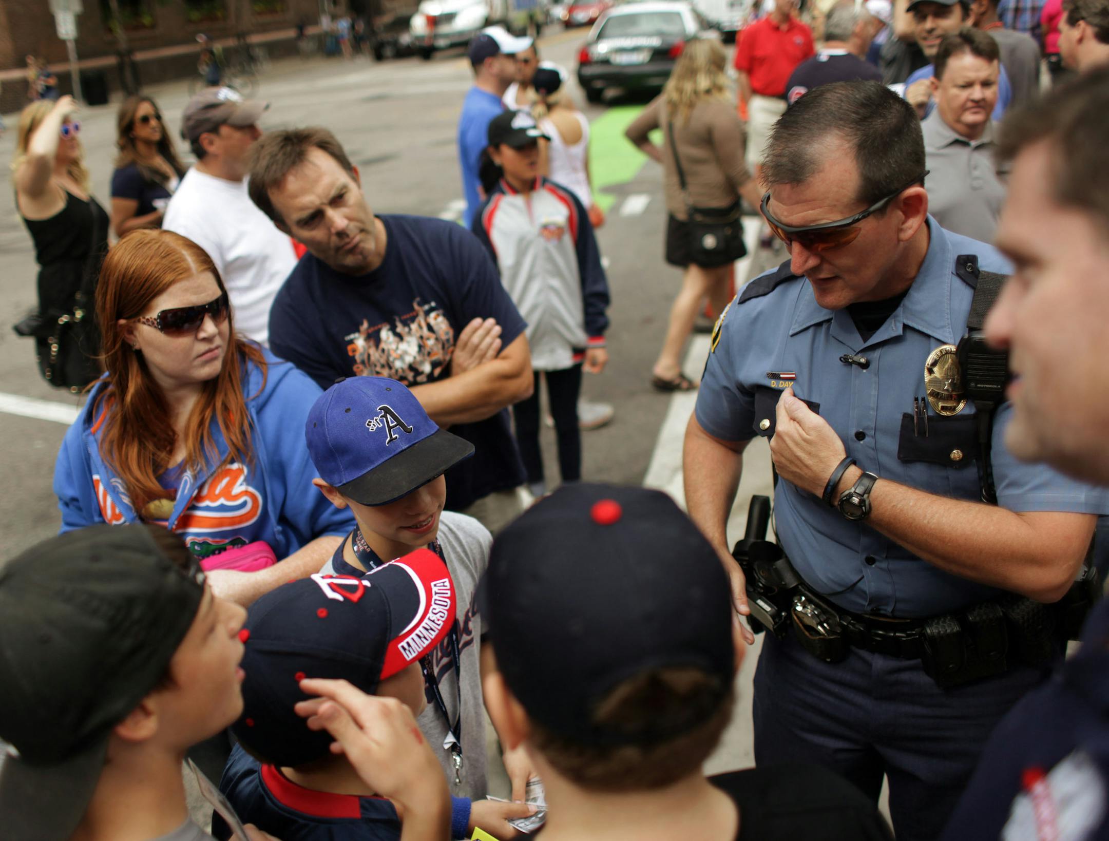 Dan Day, of the St. Paul Police, points out his name on his uniform as he patrols downtown Minneapolis on Sunday afternoon while the All Star Game festivities continue. ] MONICA HERNDON monica.herndon@startribune.com Minneapolis, MN 07/13/14