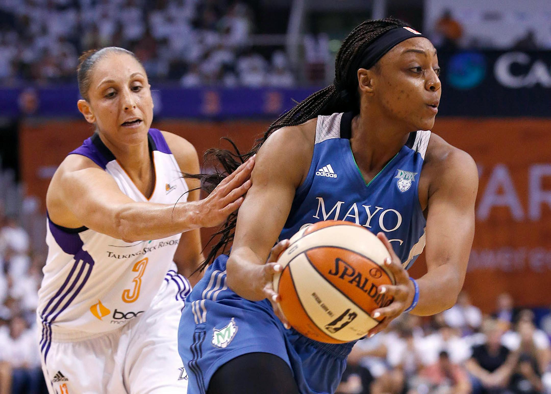 Minnesota Lynx's Monica Wright, right, drives past Phoenix Mercury's Diana Taurasi (3) during the first half in Game 1 of the WNBA Western Conference Finals basketball game, Friday, Aug. 29, 2014, in Phoenix. (AP Photo/Ross D. Franklin)