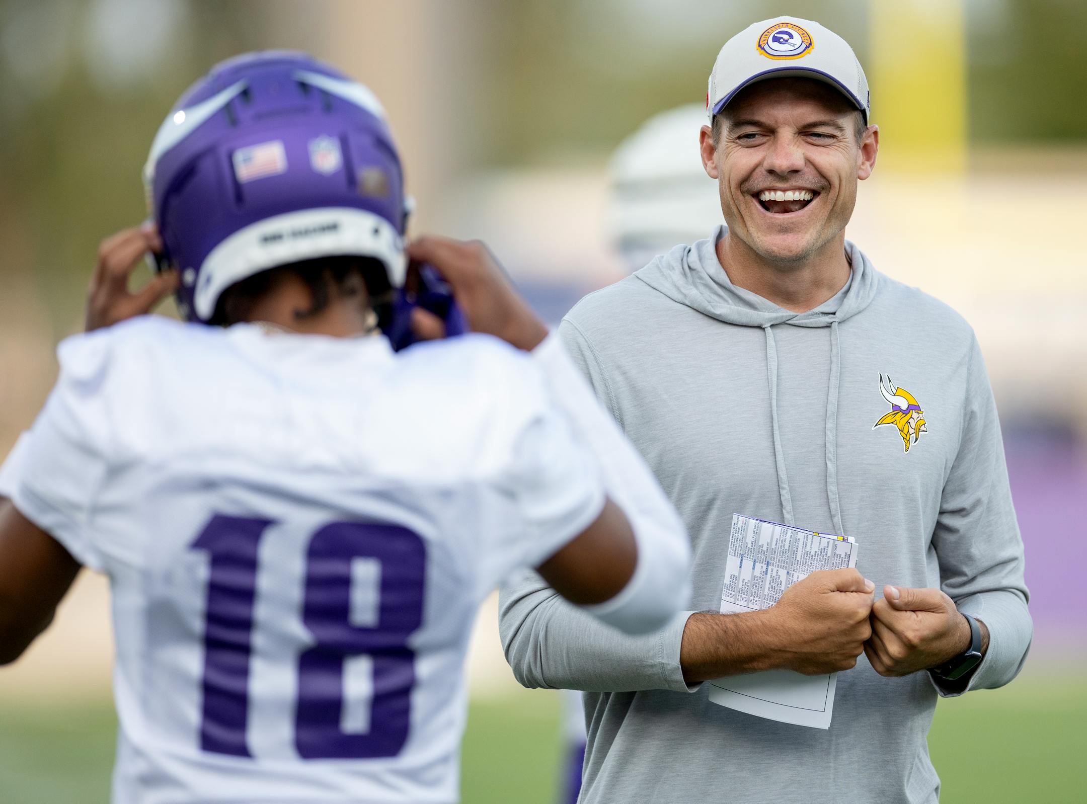 Minnesota Vikings head coach Kevin O'Connell talks with receiver Justin Jefferson (18) during evening practice Tuesday, August 8, 2023, at TCO Stadium in Eagan, Minn.