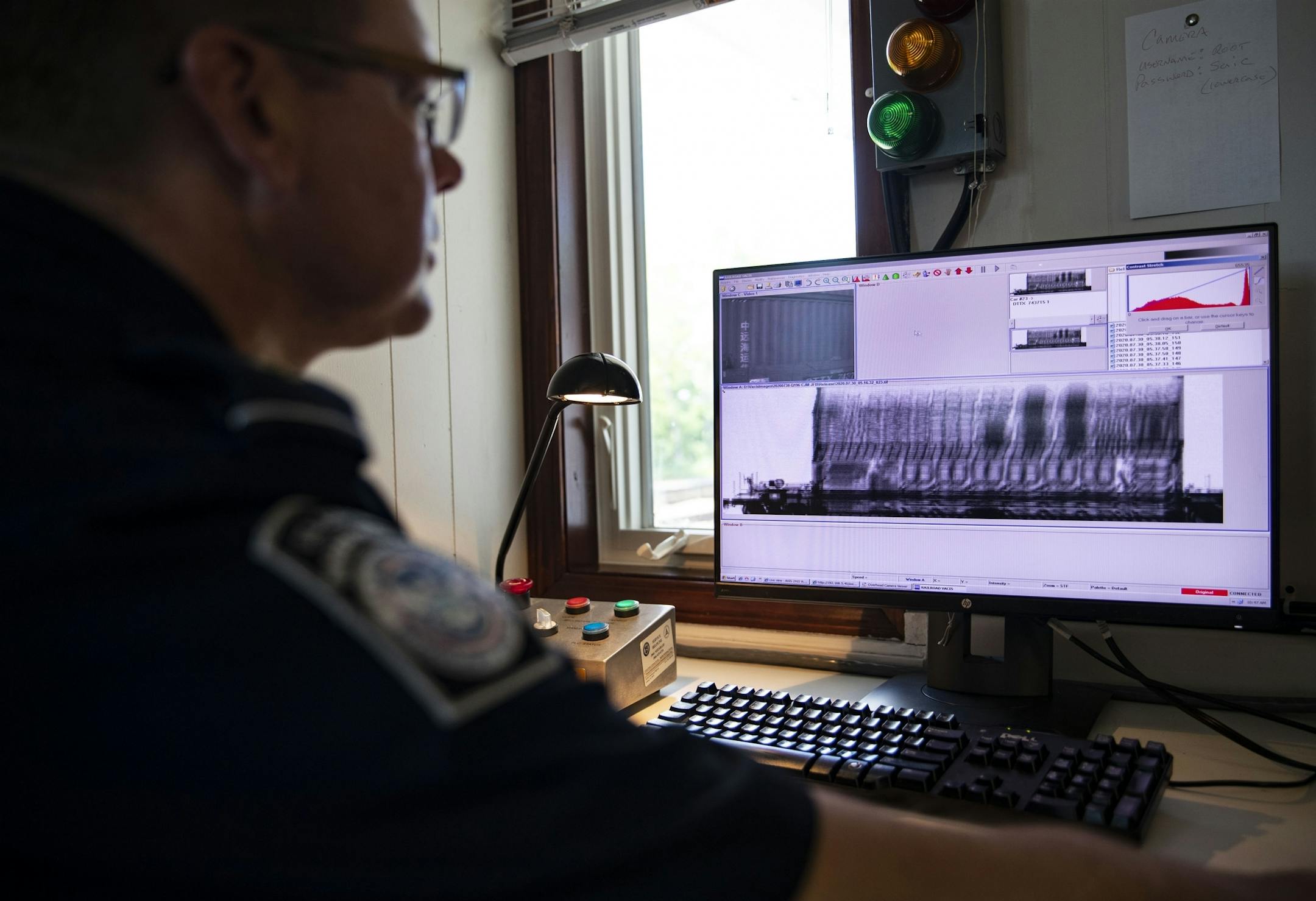 A U.S. Customs and Border Protection agent pointed out how to read an X-Ray from a passing train car.