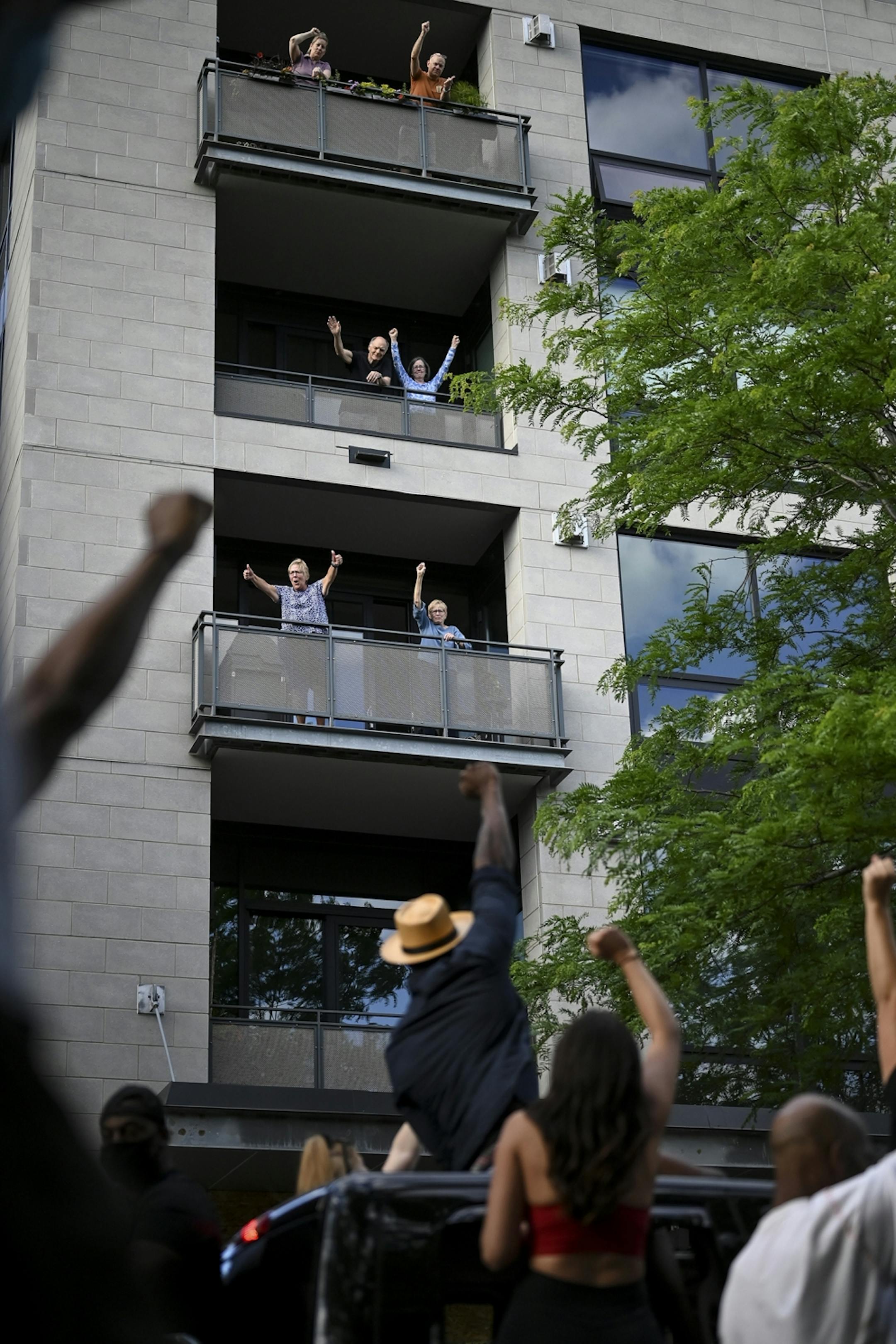 Condo residents in St. Anthony Main raised their fists in solidarity with protesters Saturday afternoon.