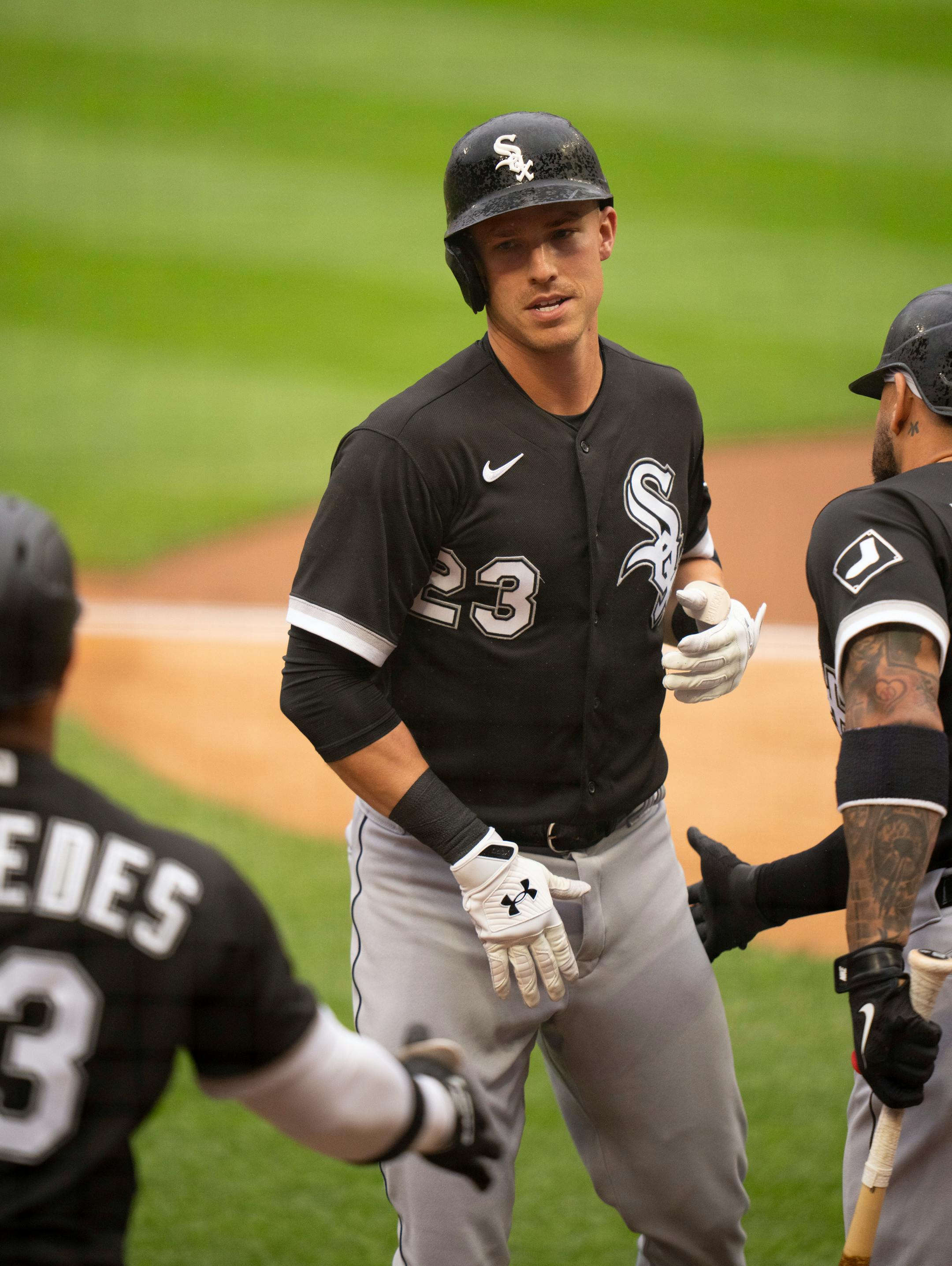 Chicago White Sox left fielder Jake Lamb (23) was congratulated by teammate Yoan Moncada (10) after his first inning solo home run.