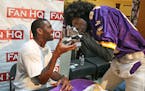 Former Viking Randy Moss said goodbye to Willie Willard, of Roseville, after signing a banner. Willard use to cook for some of the Vikings players dur