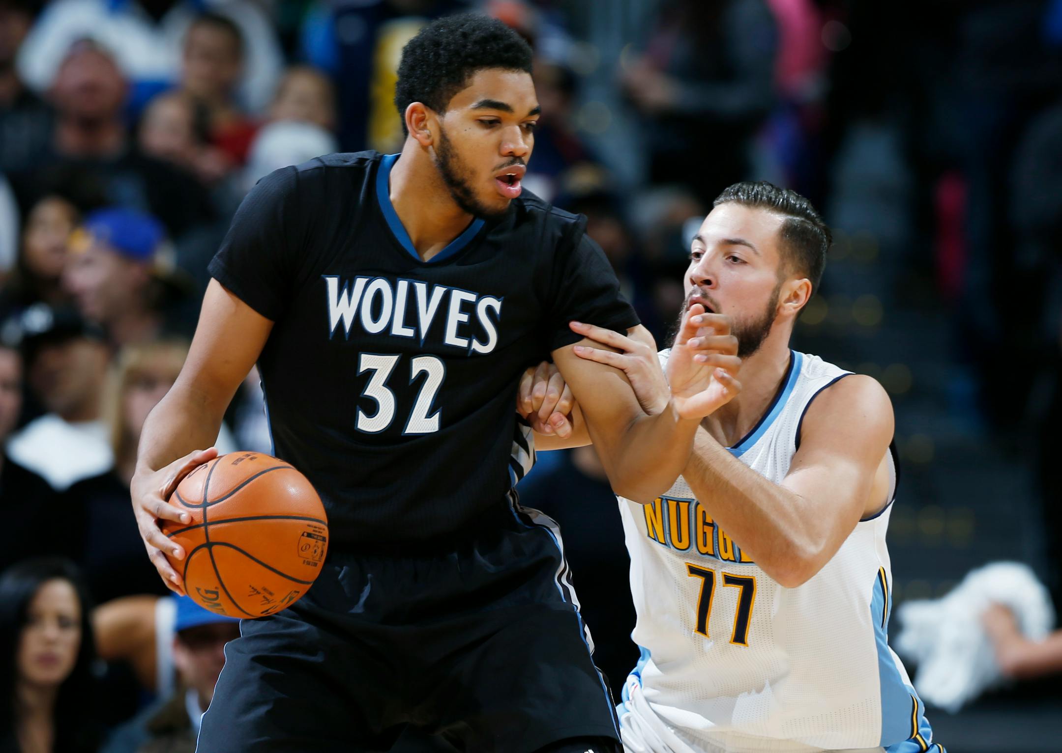 Minnesota Timberwolves center Karl-Anthony Towns, left, is tied up by Denver Nuggets forward Joffrey Lauvergne, of France, during the first half of an NBA basketball game Friday, Oct. 30, 2015, in Denver. (AP Photo/David Zalubowski)