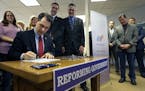 Wisconsin Gov. Scott Walker signs Assembly Bill 373 Friday, Feb. 12, 2016, at Manpower Group in Appleton, Wis. (Dan Powers /The Post-Crescent via AP) 