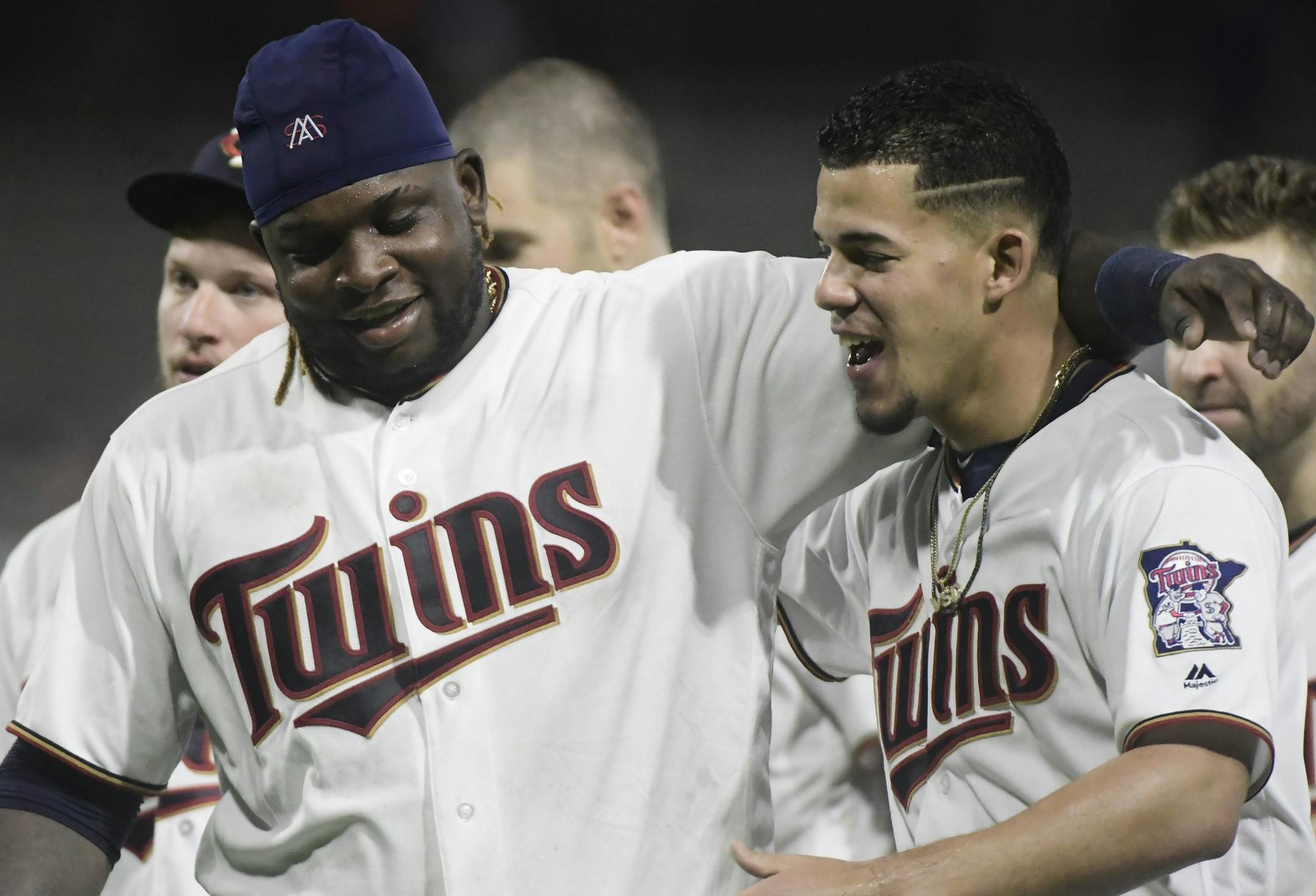 Minnesota Twins starting pitcher Jose Berrios, right, and third baseman Miguel Sano celebrate the team's 2-1 win over the Cleveland Indians in 16 innings in a baseball game at Hiram Bithorn Stadium in San Juan, Puerto Rico, early Thursday, April 19, 2018.