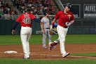 Minnesota Twins catcher Mitch Garver (18) celebrated with Minnesota Twins third base coach Tony Diaz (46) after hitting a home run in the seventh inni