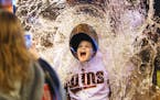 Twins fan Conner Tax, 8, of Watertown, MN, poses in a cut out of a Twins player taking a Gatorade bath while he gets his photo taken at Twinsfest, Fri