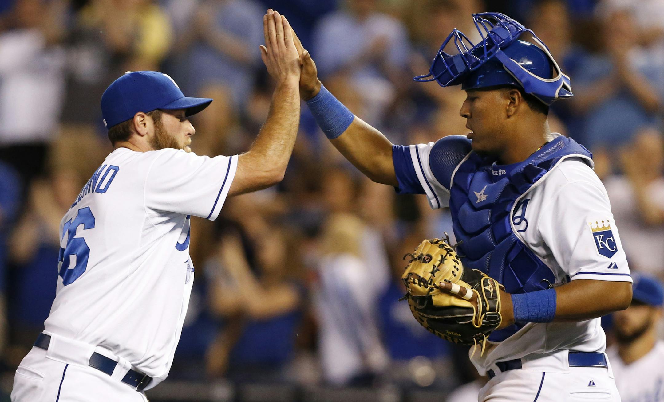 Kansas City Royals relief pitcher Greg Holland (56) high-fives catcher Salvador Perez, right, following a baseball game against the Minnesota Twins at Kauffman Stadium in Kansas City, Mo., Thursday, June 6, 2013. The Royals defeated the Twins 7-3. (AP Photo/Orlin Wagner)