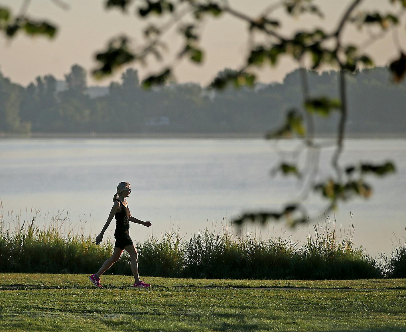 A walker made her way around Lake Calhoun, Monday, August 7, 2017 in Minneapolis, MN. ] ELIZABETH FLORES &#xef; liz.flores@startribune.com