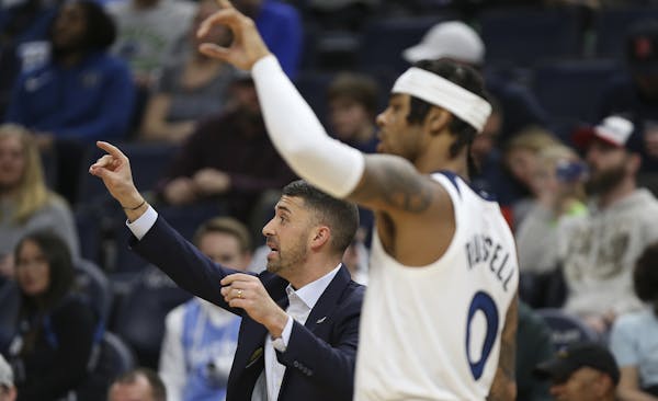 Timberwolves' head coach Ryan Saunders signals to his team alongside ' D'Angelo Russell during a game against the Dallas Mavericks.last season.