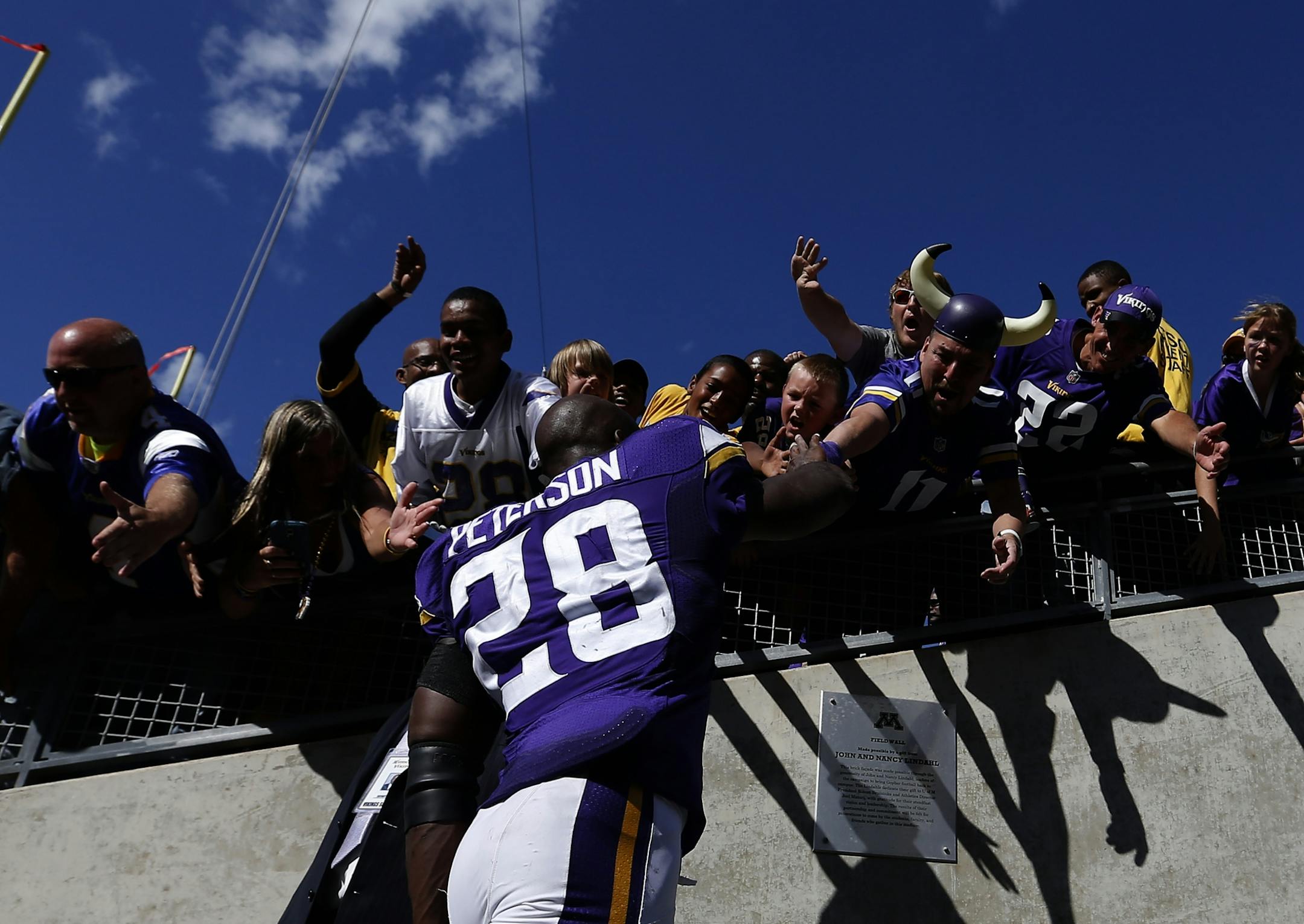 Minnesota Vikings running back Adrian Peterson (28) was greeted by fans as he walked off the field at the end of the game. Minnesota beat Detroit by a final score of 26-16.