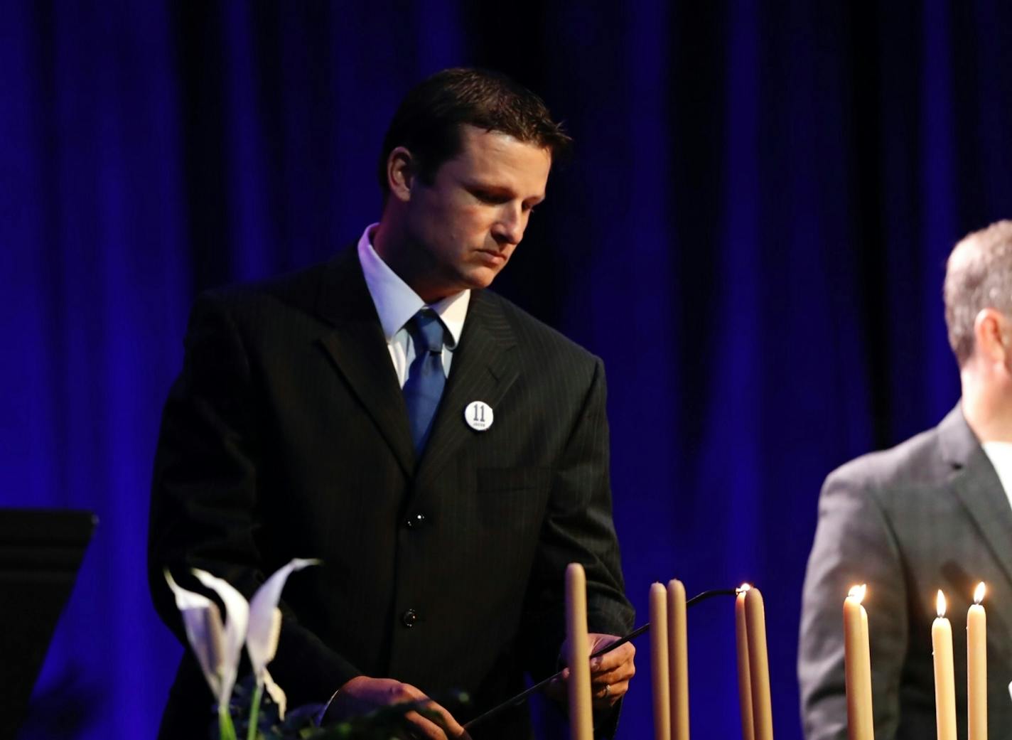 Aaron Larson, a friend of Jacob's who witnessed his abduction, lit a candle at the podium before a memorial service for Jacob Wetterling at Clemens Field House at the College of Saint Benedict in St. Joseph, Minn., on Sunday September 25, 2016.