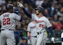Minnesota Twins' Byron Buxton, right, is congratulated by Miguel Sano after hitting a three-run home run off of starting pitcher Erik Swanson that sco