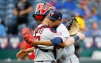 Minnesota Twins catcher Ryan Jeffers, left, hugs relief pitcher Jorge Alcala, right, as they celebrate their win over the Kansas City Royals at the en