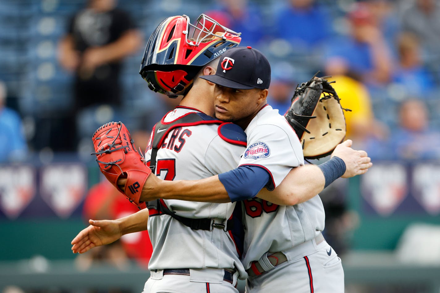 Minnesota Twins catcher Ryan Jeffers, left, hugs relief pitcher Jorge Alcala, right, as they celebrate their win over the Kansas City Royals at the end of a baseball game in Kansas City, Mo., Sunday, Oct. 3, 2021. (AP Photo/Colin E. Braley)