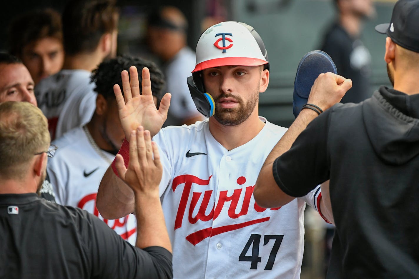 Minnesota Twins' Edouard Julien celebrates in the dugout after against the Texas Rangers during the third inning of a baseball game Saturday, Aug. 26, 2023, in Minneapolis. The Rangers won 6-2. (AP Photo/Craig Lassig)