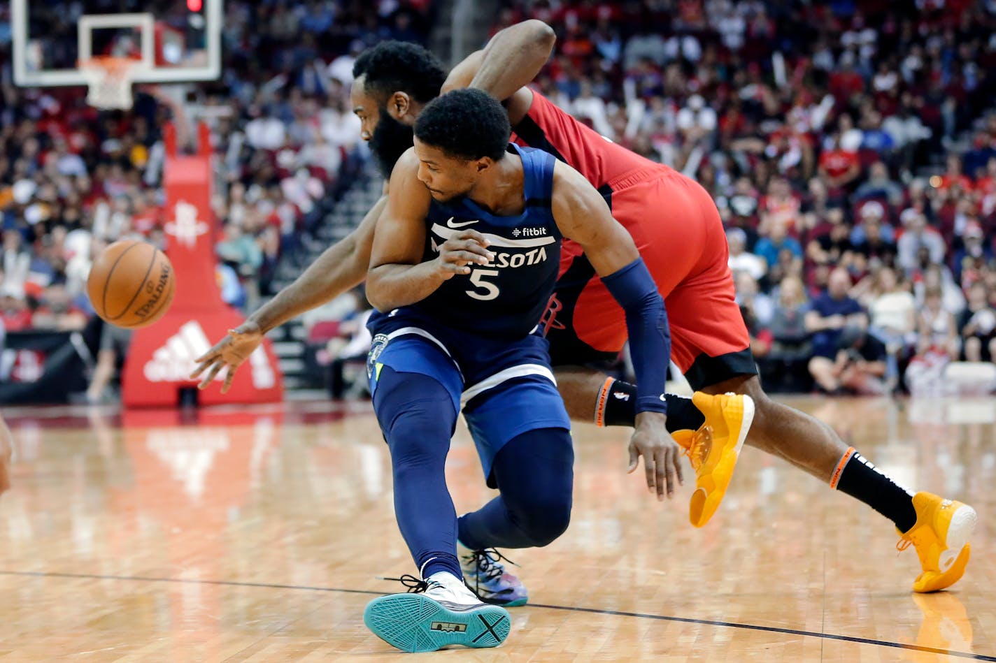 Rockets guard James Harden reaches behind Timberwolves guard Malik Beasley