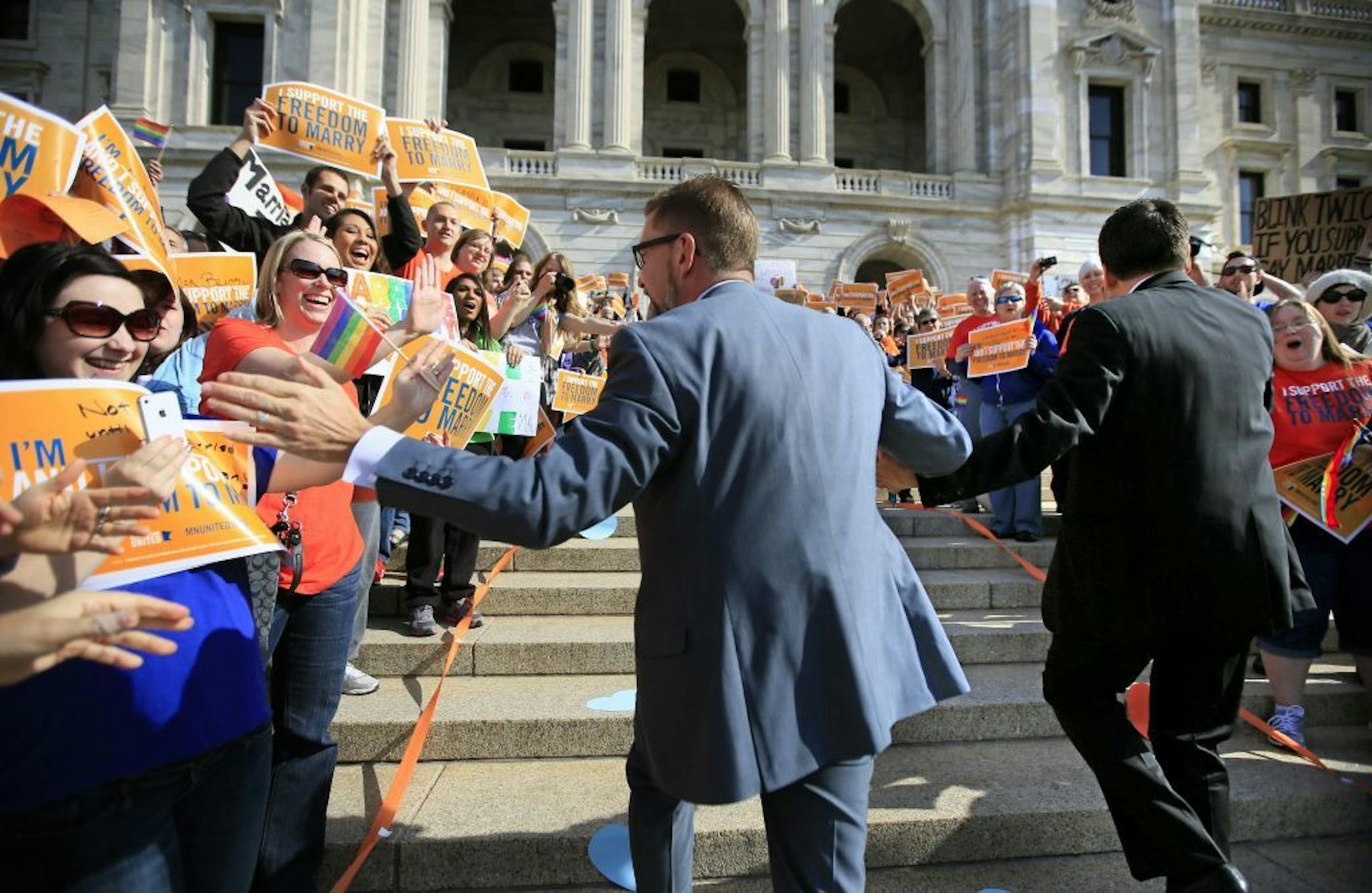The Minnesota Senate will bring to a close the state's long and wrenching conversation about same-sex marriage as it takes votes to legalize gay couples' unions. Early monday morning, senators were greeted by a large cheering crowd of Same Sex Marriage supporters on the Capitol steps. Here, Senator Scott Dibble and his husband Richard Leyva run up the capitol steps, hand-in-hand, greeted by a cheering crowd of supporters.