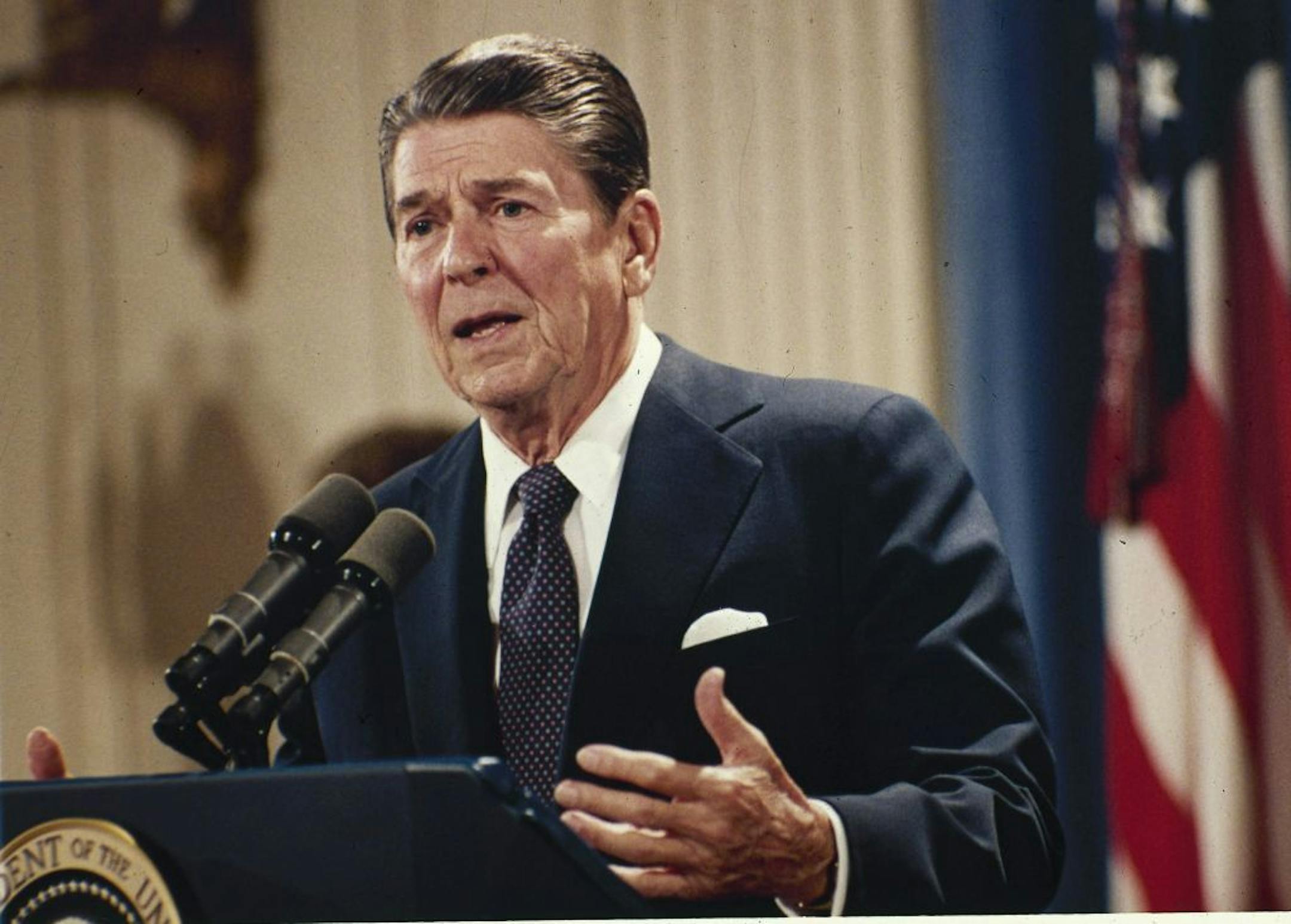 FILE - In this Oct. 19, 1983 file photo, President Ronald Reagan speaks during a news conference at the White House in Washington. President Barack Obama's impending unilateral order awarding legal status to millions of immigrants is not unprecedented. Two of the last three Republican presidents _ Ronald Reagan and George H.W. Bush _ did the same thing in extending amnesty to family members not covered by the last major overhaul of immigration law in 1986. There was no political explosion then c
