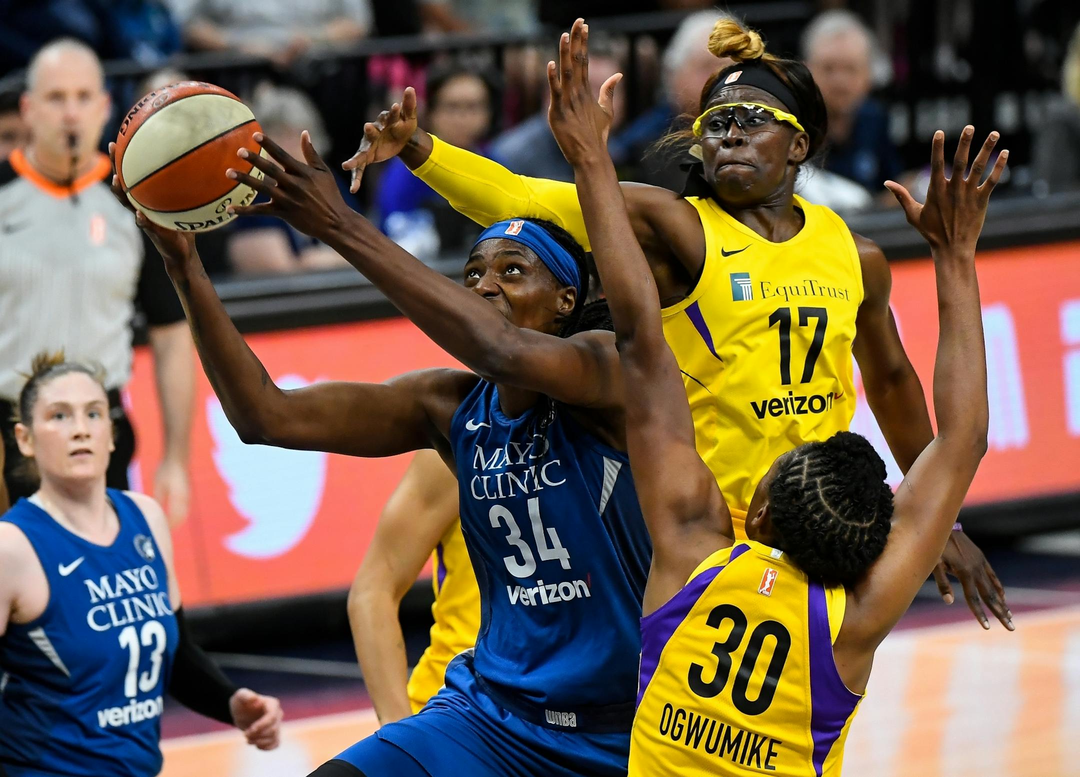 Minnesota Lynx center Sylvia Fowles (34) powered through the defense of Los Angeles Sparks forward Essence Carson (17) and forward Nneka Ogwumike (30) in the first quarter for a layup.