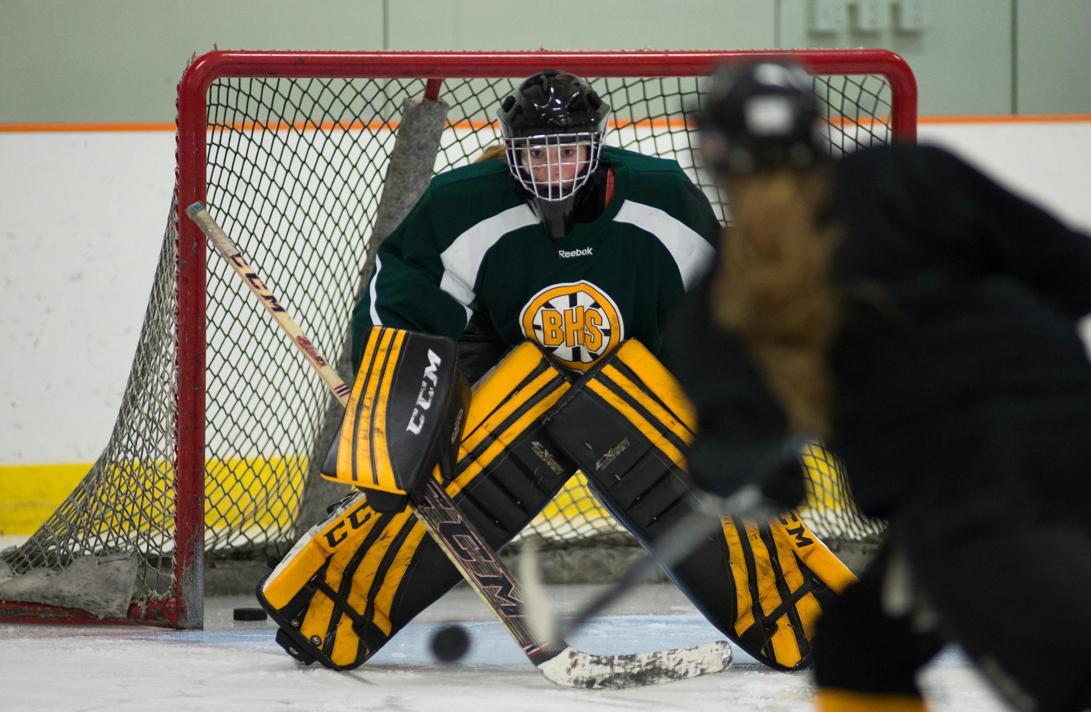 Burnsville junior goalie and captain, Lauren Bench, takes practice shots from her teammates before Friday's scrimmage against Farmington. ] AARON LAVINSKY • aaron.lavinsky@startribune.com The Burnsville Blaze scrimmaged against the Farmington Tigers at Schmitz-Maki Arena Friday, October 31, 2014 in Farmington. Farmington won the scrimmage with an unofficial score of 5-1.