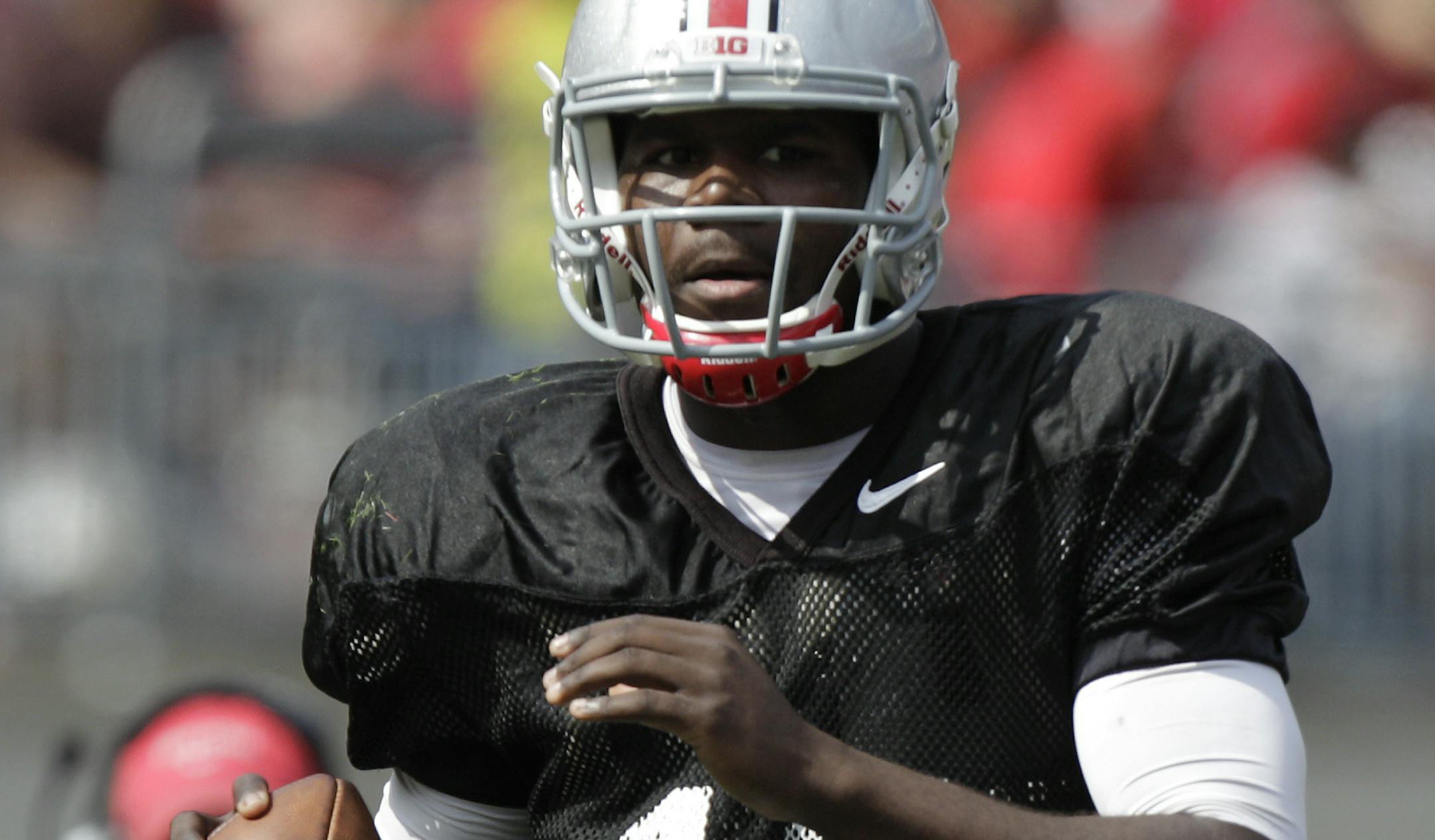 FILE - In this April 12, 2014, file photo, Ohio State quarterback Cardale Jones looks downfield during their spring NCAA college football game in Columbus, Ohio. After Ohio State lost quarterback Braxton Miller in the preseason to a shoulder injury, J.T. Barrett had a big year before breaking his ankle against Michigan. Now the Buckeyes turn to Cardale Jones in the Big Ten title game against Wisconsin on Saturday, Dec. 6, 2014. (AP Photo/Jay LaPrete, File)