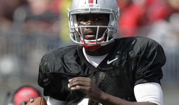 FILE - In this April 12, 2014, file photo, Ohio State quarterback Cardale Jones looks downfield during their spring NCAA college football game in Colu