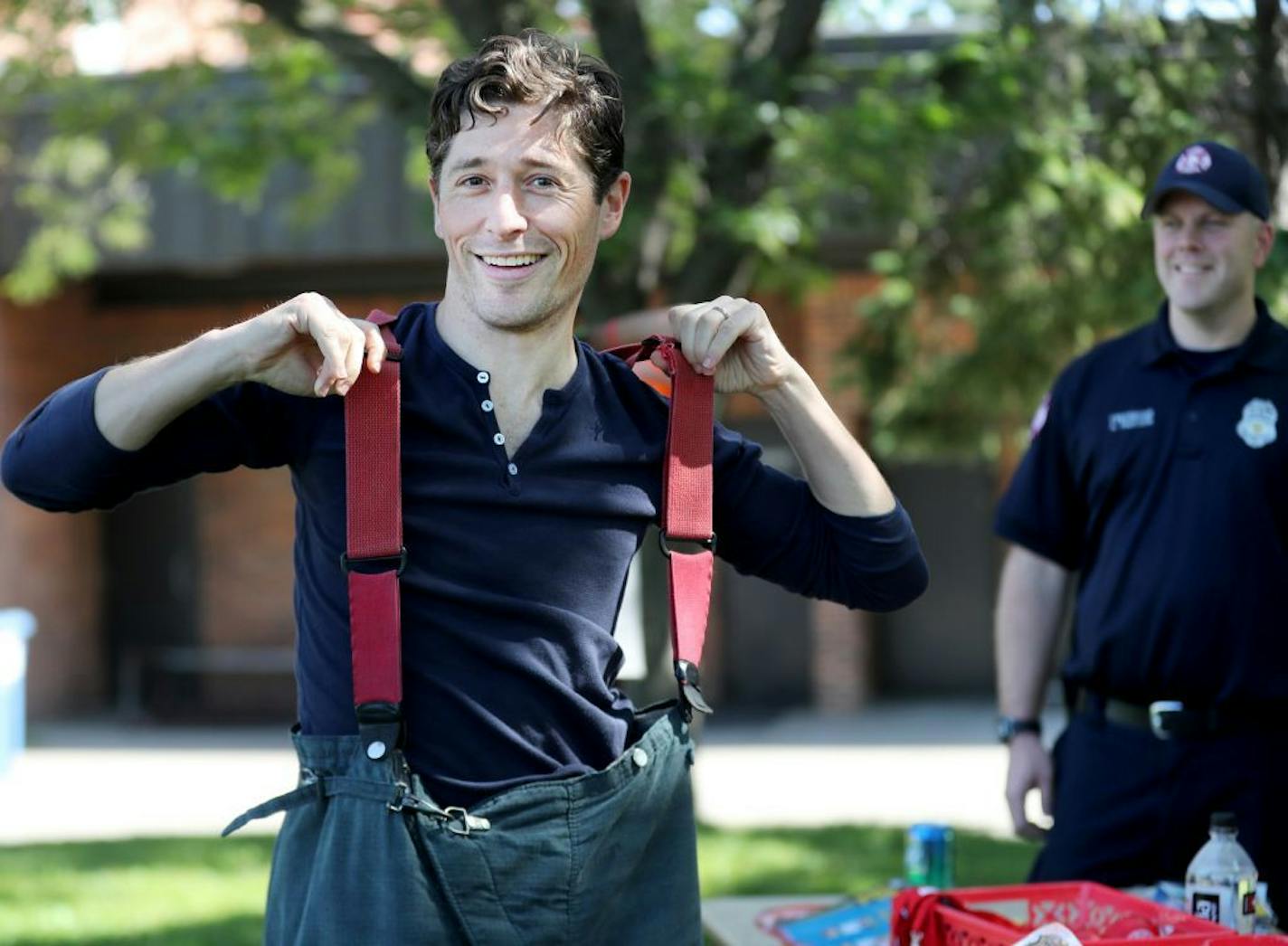 Jacob Frey, current Minneapolis City council member and mayoral candidate, worked the crowd at Open Streets Minneapolis on West Broadway. Here, Frey tried on a firefighter's turnout gear while chatting with firefighters from Minneapolis Fire Station 7 Saturday, Sept. 9, 2017, in Minneapolis, MN.