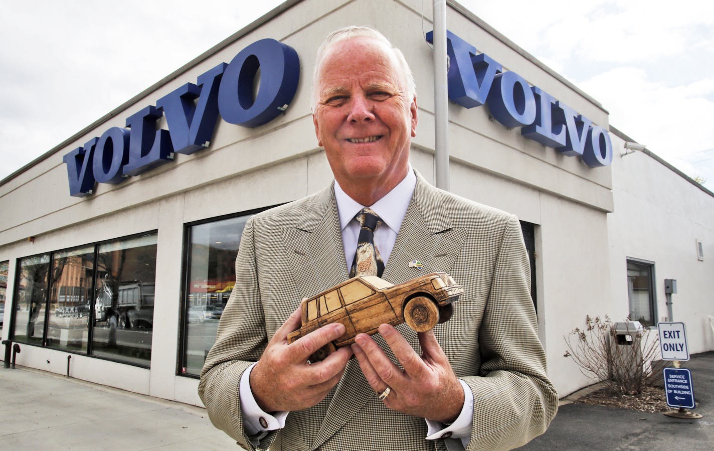 Borton Volvo chairman Kjell Bergh holding a wooden model of a 1982 Volvo 740 stands in front of his south Minneapolis dealership. ] Borton Volvo is moving from its south Minneapolis location to new headquarters in Golden Valley. (MARLIN LEVISON/STARTRIBUNE(mlevison@startribune.com)