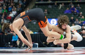 Mound Westonka wrestler Jack Nelson attempts to take down Grand Rapids wrestler Alex Lehman during the MSHSL wrestling state tournament Friday, March 