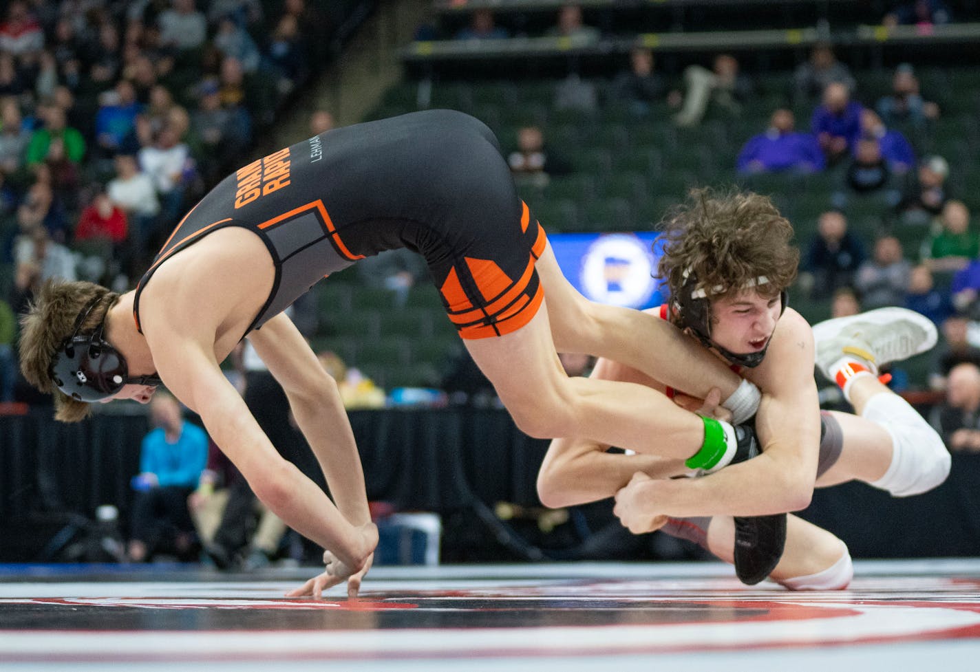 Mound Westonka wrestler Jack Nelson attempts to take down Grand Rapids wrestler Alex Lehman during the MSHSL wrestling state tournament Friday, March 3, 2023 at Xcel Energy Arena in St. Paul, Minn. ]