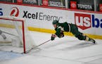 Wild center Nico Sturm&nbsp;makes a wraparound shot for goal against the San Jose Sharks during the second period