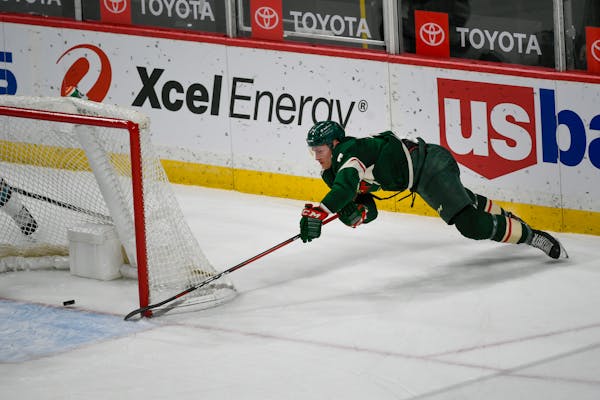 Wild center Nico Sturm&nbsp;makes a wraparound shot for goal against the San Jose Sharks during the second period