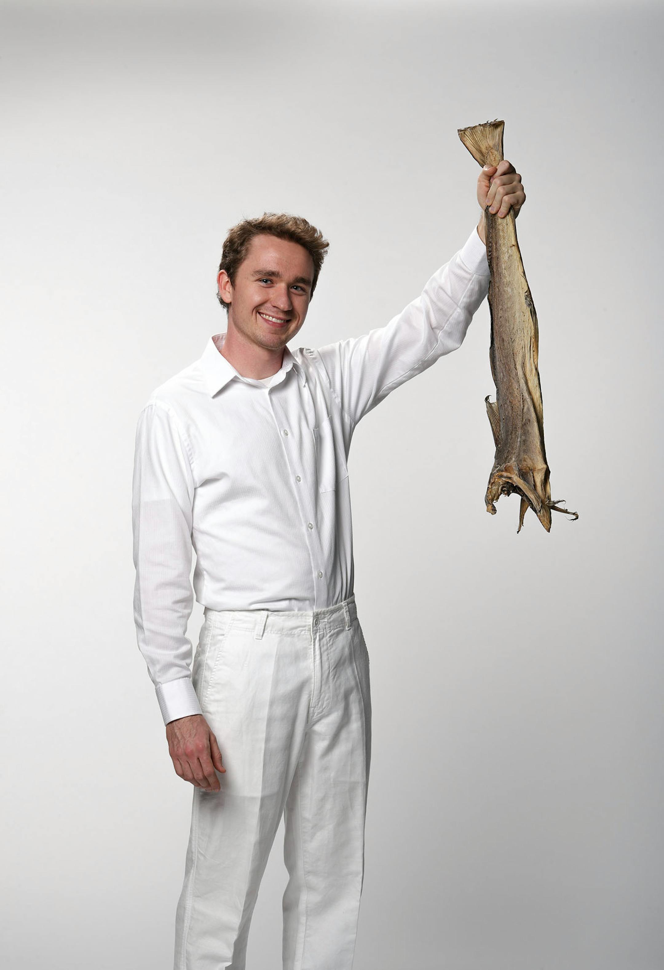 Nels Thompson with a dried cod, the basis of many a Scandinavian holiday meal. ] JEFF WHEELER ï jeff.wheeler@startribune.com Nels Thompson took over planning the traditional Scandinavian holiday meal at his church with the intent of making it appeal to twentysomethings like himself. He was photographed with dried cod in the StarTribune studio on Thursday afternoon, November 3, 2016.
