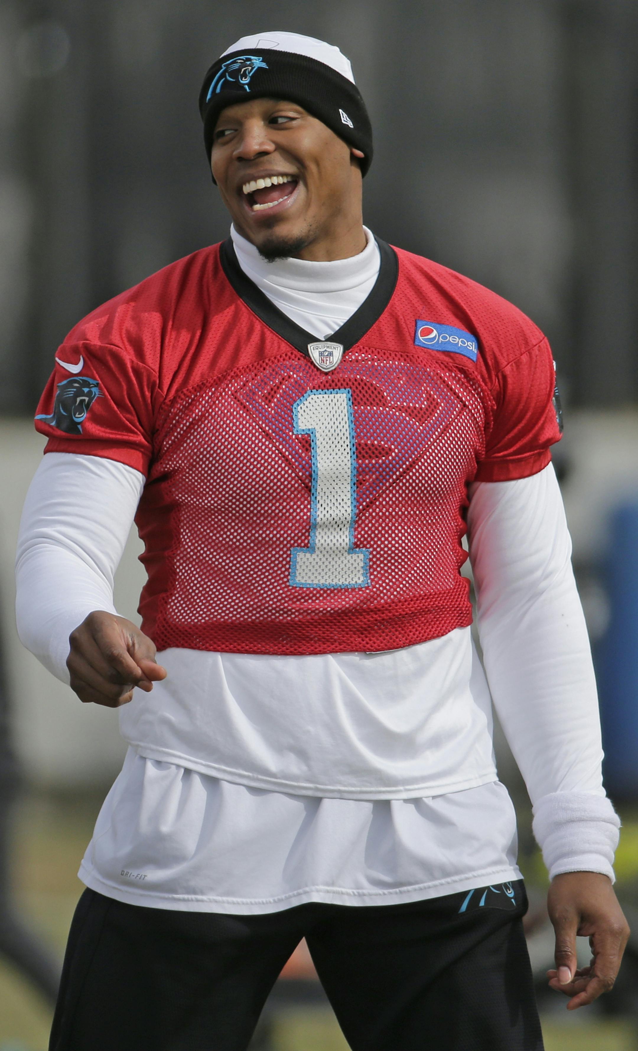Carolina Panthers' Cam Newton jokes with teammates during practice for the NFL football team in Charlotte, N.C., Wednesday, Jan. 27, 2016. (AP Photo/Chuck Burton)