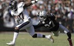 Baltimore Ravens wide receiver Mike Wallace (17) runs past Oakland Raiders free safety Reggie Nelson (27) during the second half of an NFL football ga