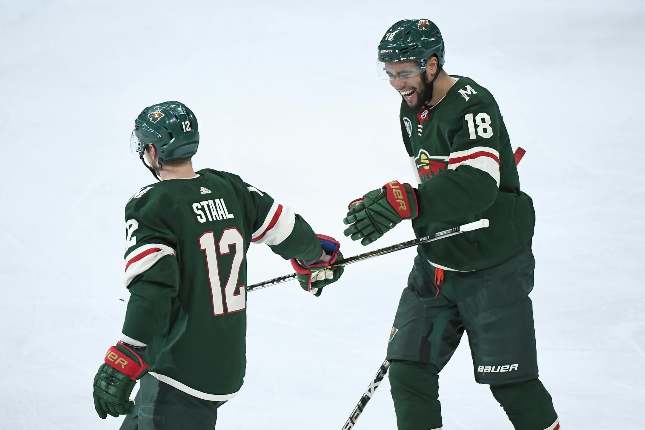 Minnesota Wild center Eric Staal (12) celebrated with left wing Jordan Greenway (18) after Staal's third period goal against the Los Angeles Kings.