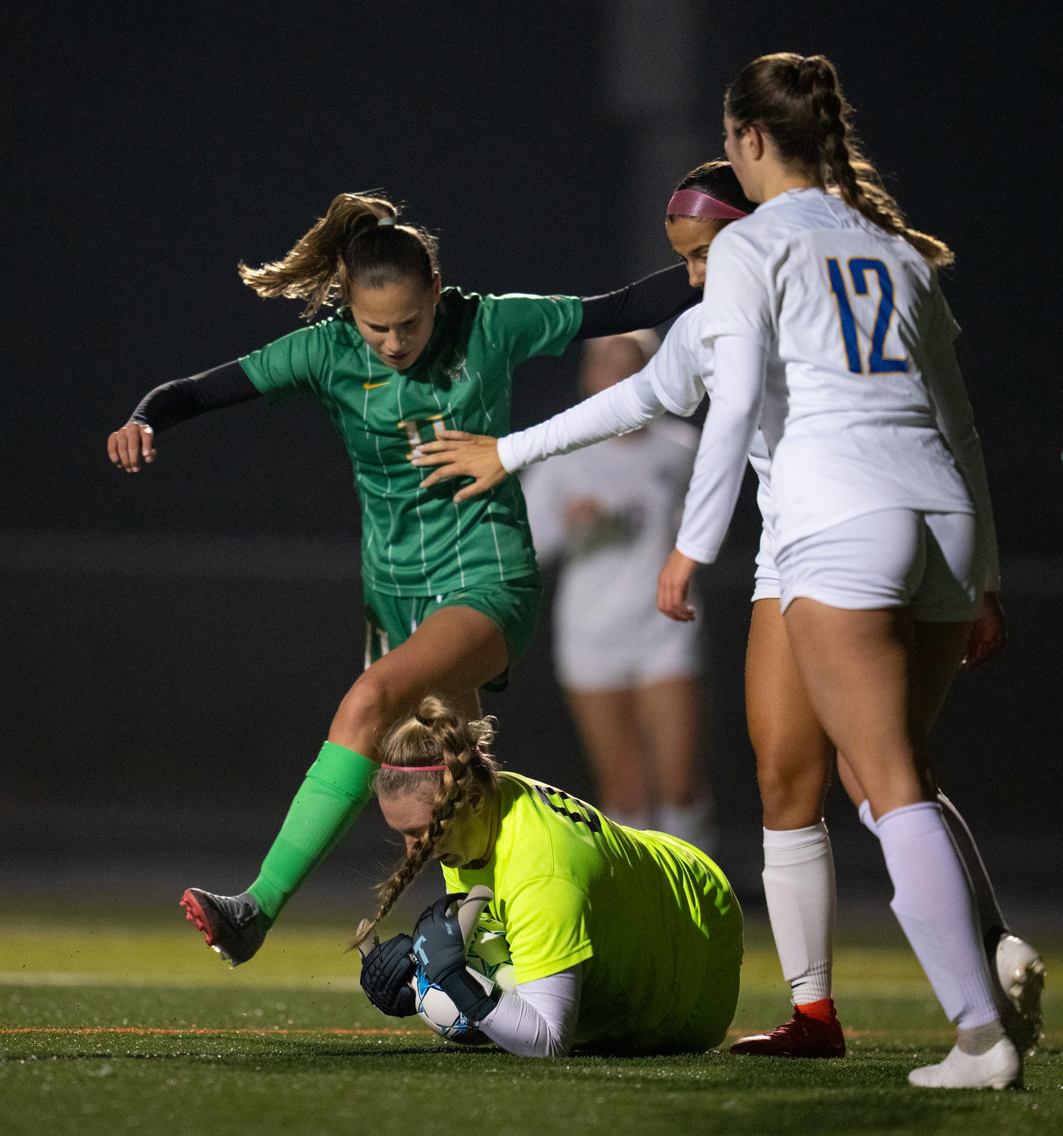 St, Michael-Albertville keeper grabbed a loose ball ahead of Edina's Lou Ruffien in the first half.