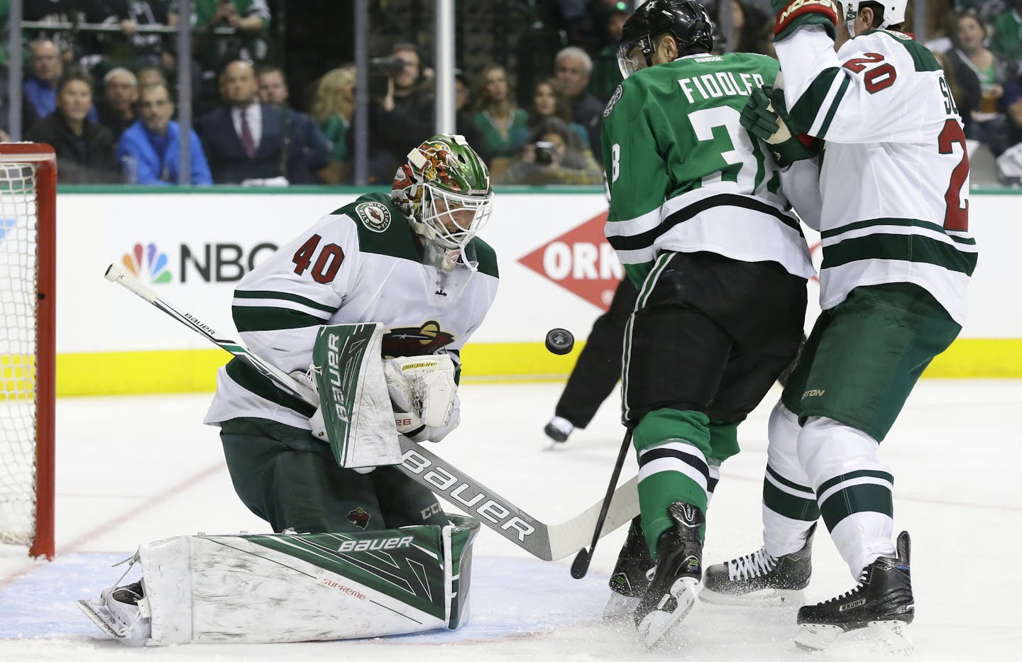 Minnesota Wild goalie Devan Dubnyk (40) and defenseman Ryan Suter (20) defend the goal against Dallas Stars center Vernon Fiddler (38) during the first period of Game 1 in a first-round NHL hockey Stanley Cup playoff series Thursday, April 14, 2016, in Dallas. (AP Photo/LM Otero)