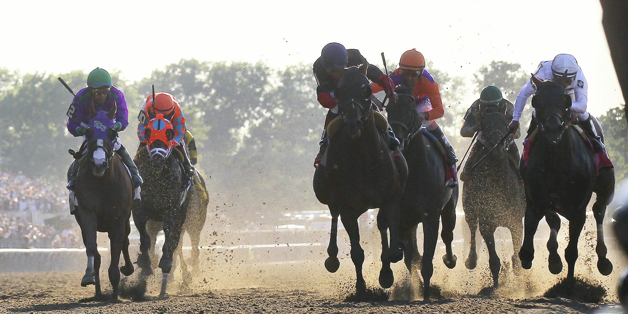 Tonalist, center, catches Commissioner, right, at the finish line to win the 146th running of the Belmont Stakes, in Elmont, N.Y., June 7, 2014. Running from the outside gate, Tonalist foiled a bid by California Chrome, far left, to become the first Triple Crown winner since 1978. (Chang W. Lee/The New York Times)