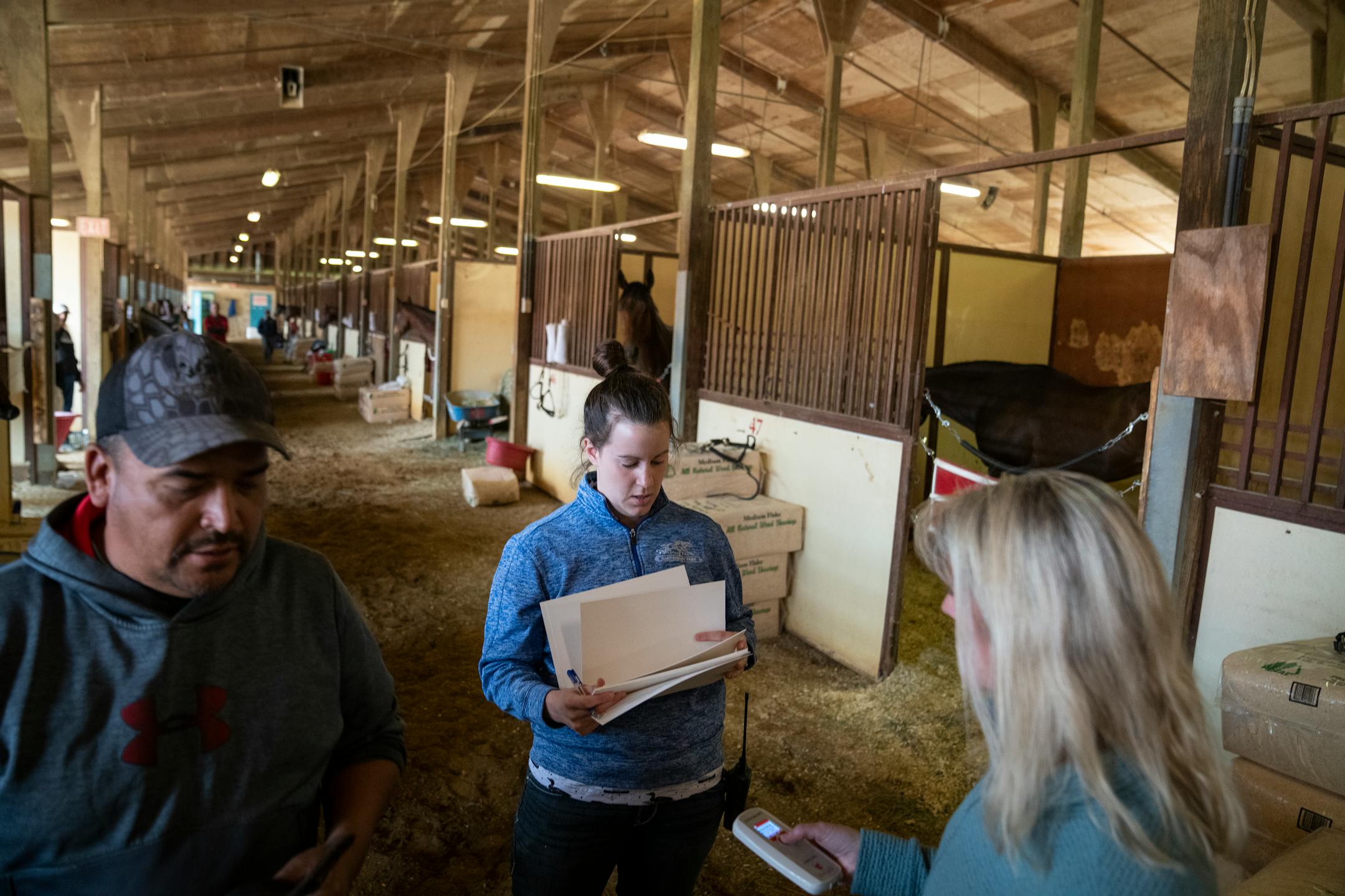 Veterinarians Dr. Rebecca Butler, center, and at Dr. Christy Klatt, right, make the rounds performing exams on horses that have not raced in 180 days or more.